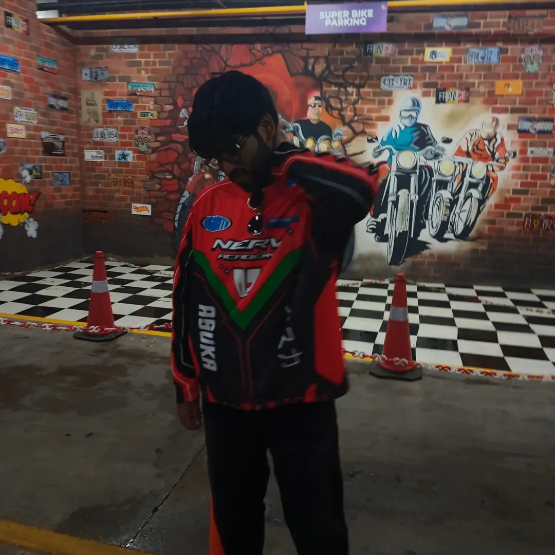 Avinash in a red and black racing jacket