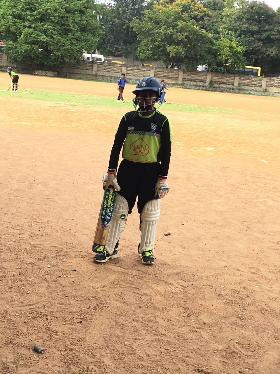 Young Avinash in full cricket kit, batting gear on