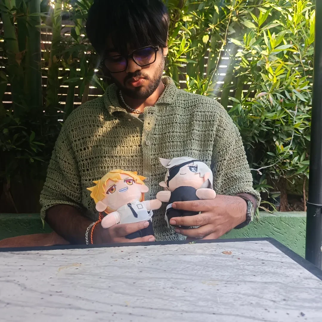 Avinash holding two anime plushies